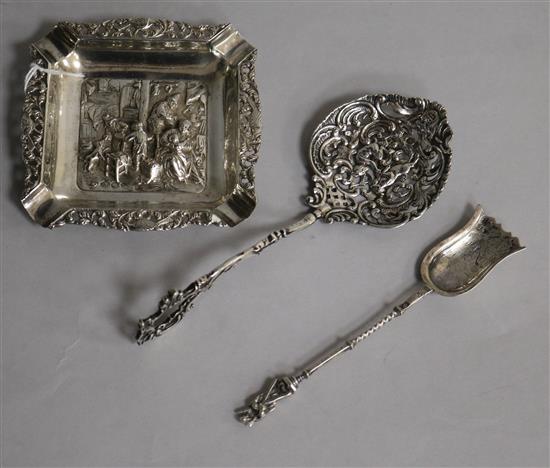 A 20th century Dutch white metal repousse ashtray, Dutch white metal spoon and a Hanau white metal pierced spoon.